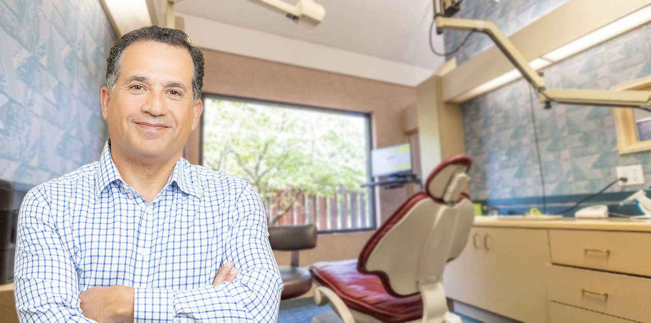 Lorain Ohio endodontist Doctor Peyman Vaziri smiling in endodontic office