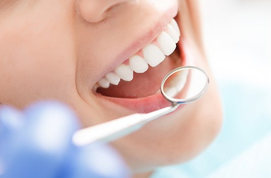 a patient smiling and sitting in a dental chair